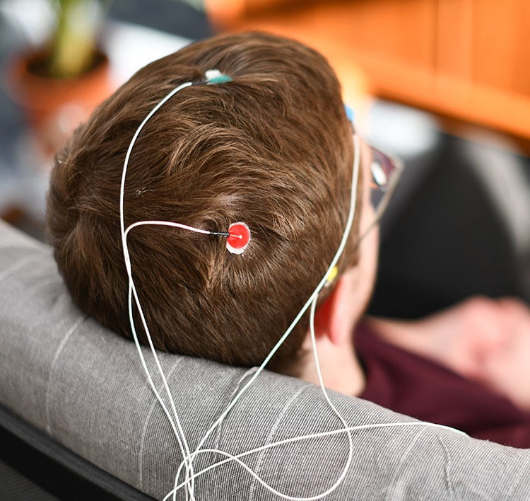 Neurofeedback therapy, person with sensors on head for neurofeedback session